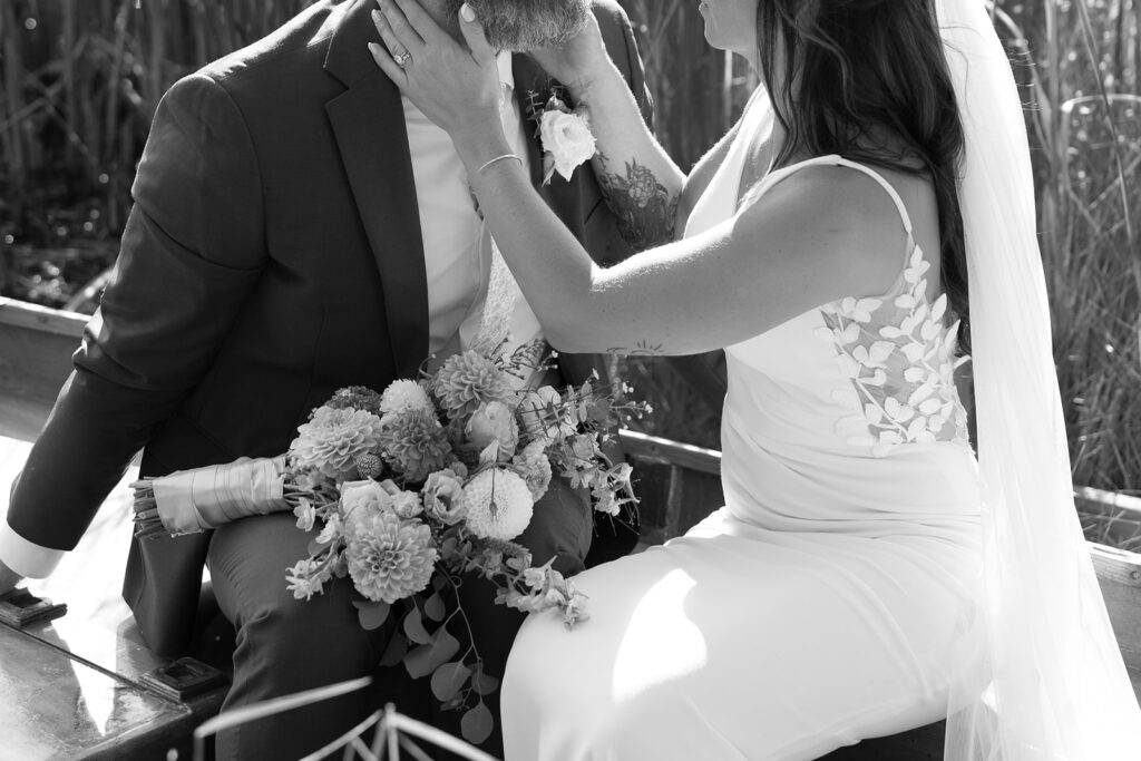 Karis and Tony go in for a kiss while sitting in the canoe at Bloom and Bower