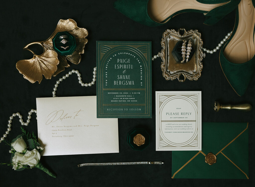 wedding detail photos flat lay with rings, invitation, shoes, pearls, stamps, and brides ring