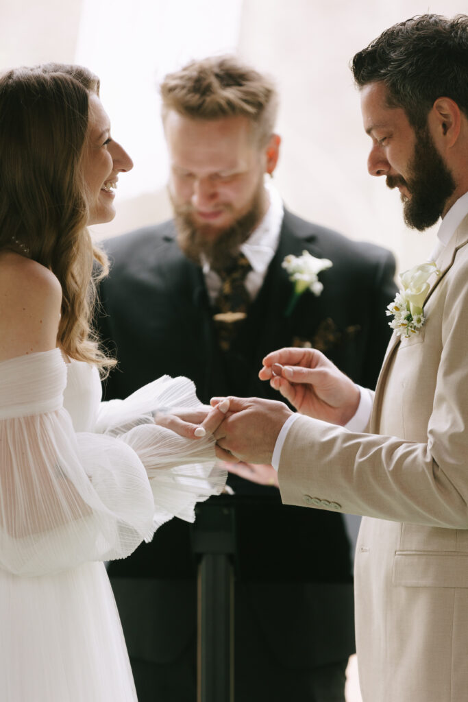 Wedding coordinator adjusting a bride’s veil before the ceremony begins