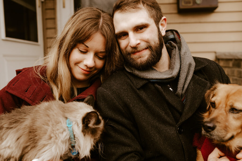 Couple with both their dog and cat at their engagement session