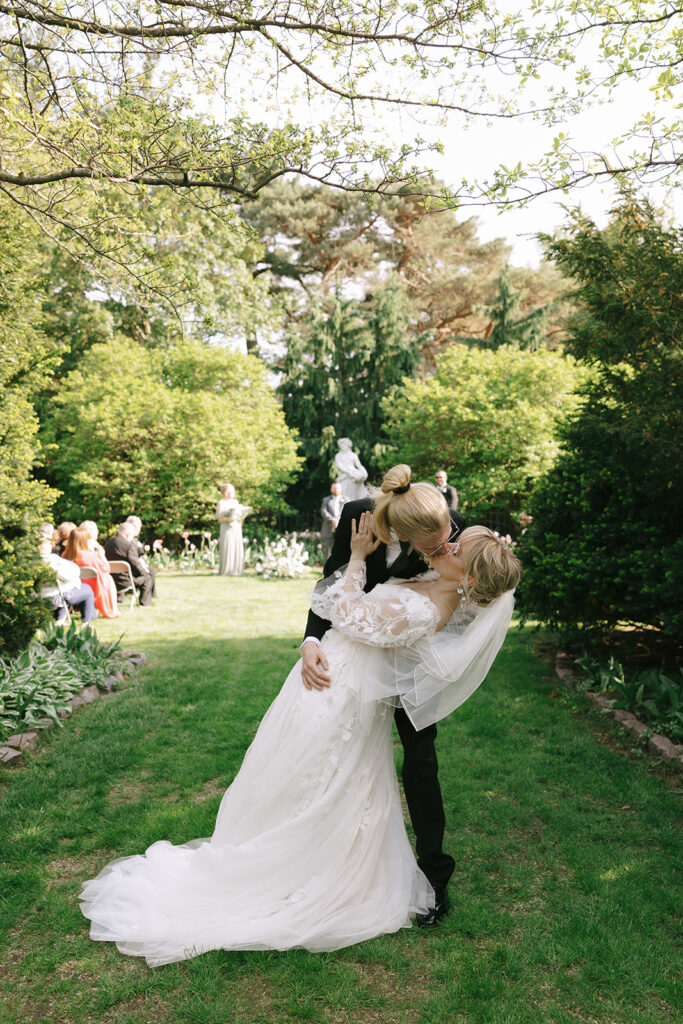 Groom dipping the bride into a playful kiss, letting go of prewedding nerves together

