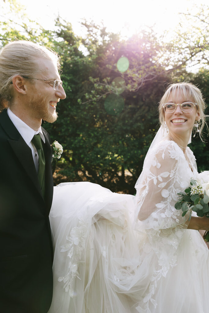 Laughing couple in wedding attire, letting go of prewedding nerves before walking down the aisle

