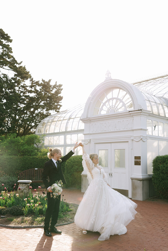 Bride and groom twirling playfully together to shake off prewedding nerves before the ceremony.

