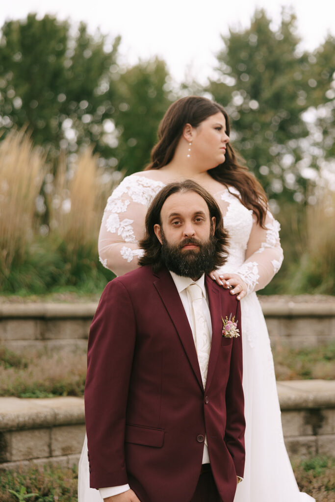 Bride and groom posing outdoors, bride standing behind groom with arm wrapped around him, a portrait that ties back to preparation advice in tips for the morning of your wedding.
