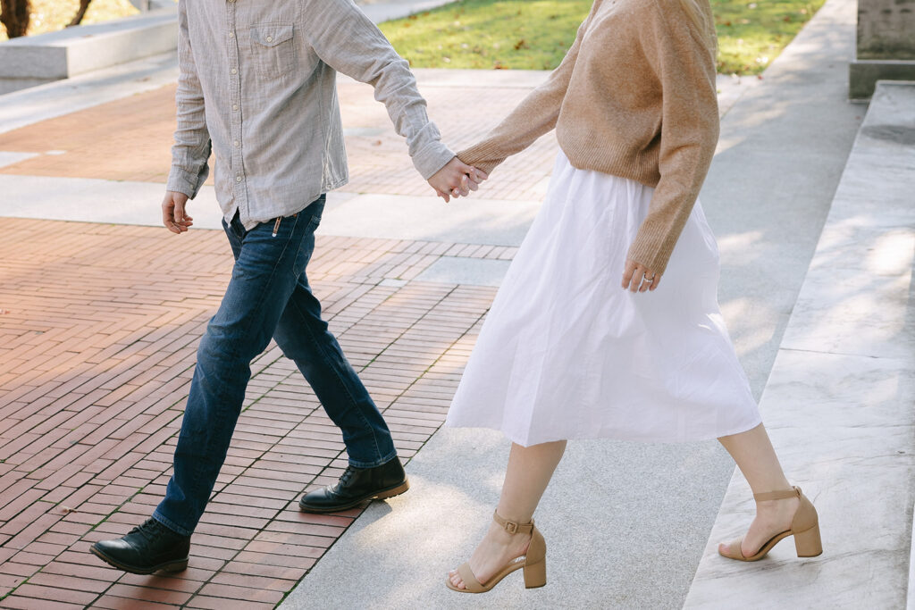 Man and woman walking while hoding hands