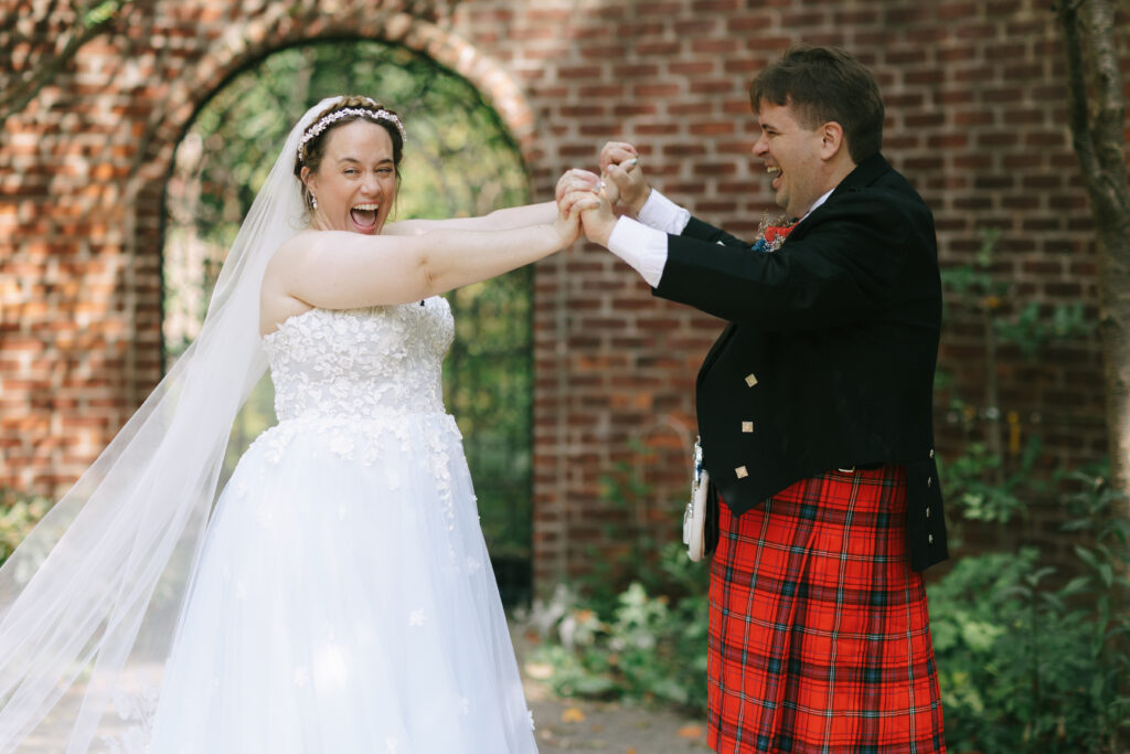Bride and groom holding hands and laughing candid wedding photography by Sokolco.