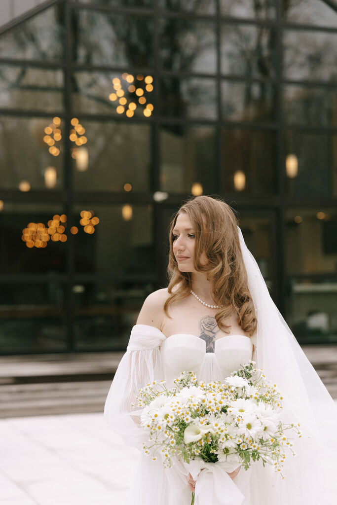 Bride looking to the side protecting her wedding day energy.
