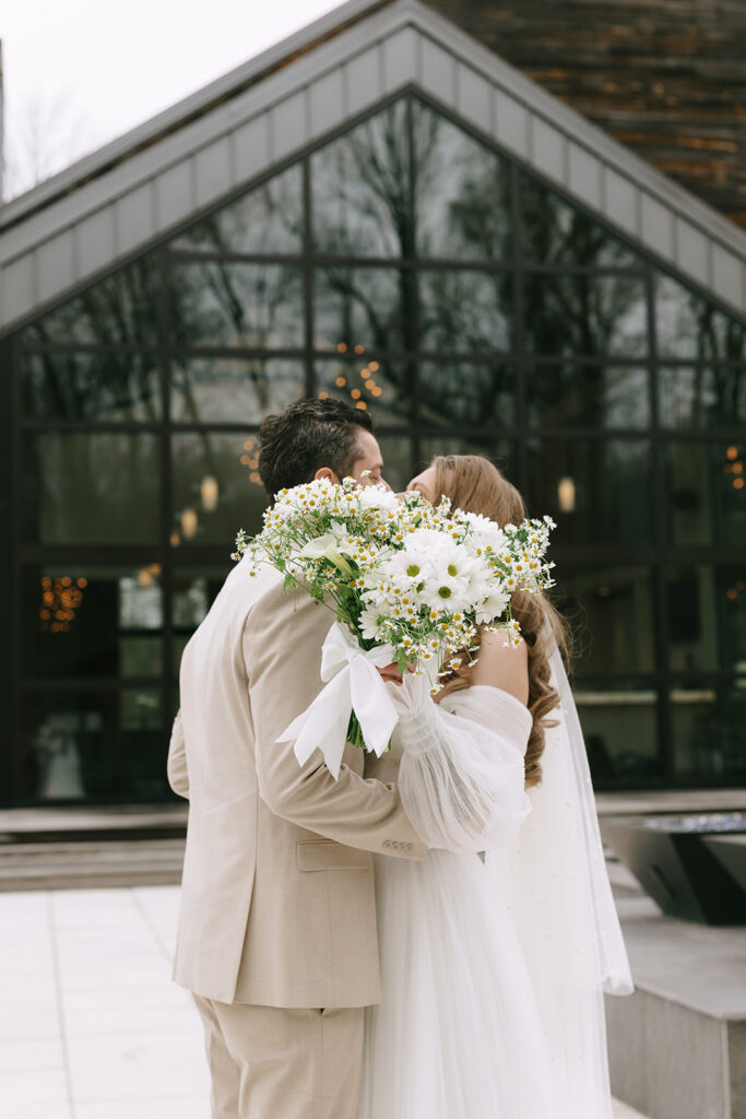 Partners kissing and protecting their wedding day energy.