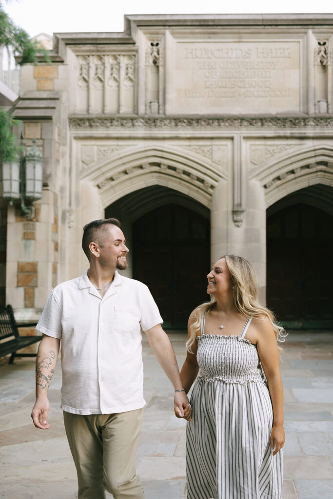 Close-up of an engaged couple holding hands in dappled sunlight