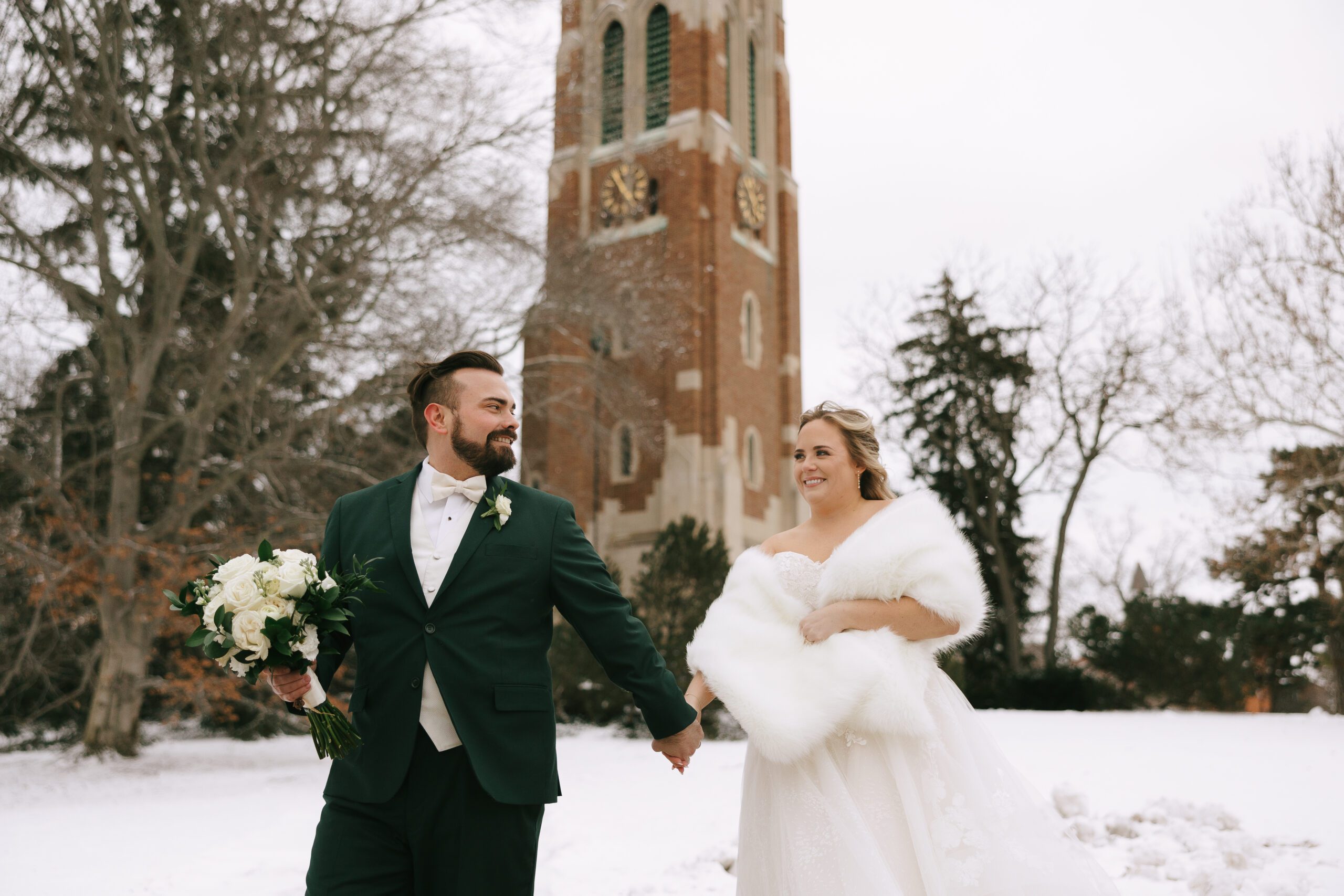 Couple walking in front of Michigan State University campus clocktower, Beaumont Tower